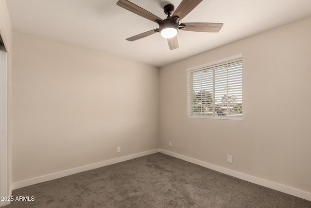 spare room featuring a ceiling fan, baseboards, and dark carpet
