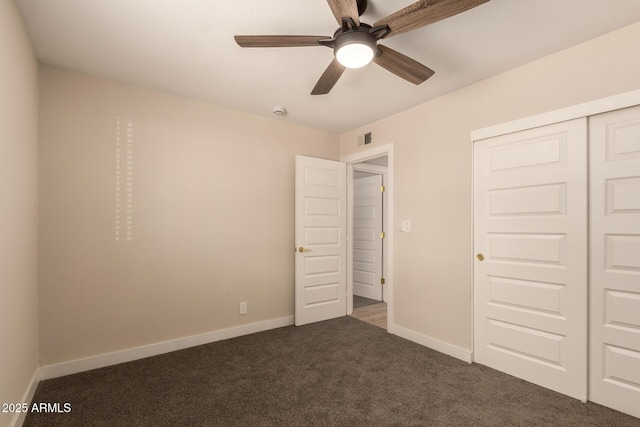 unfurnished bedroom with a closet, visible vents, carpet, baseboards, and ceiling fan