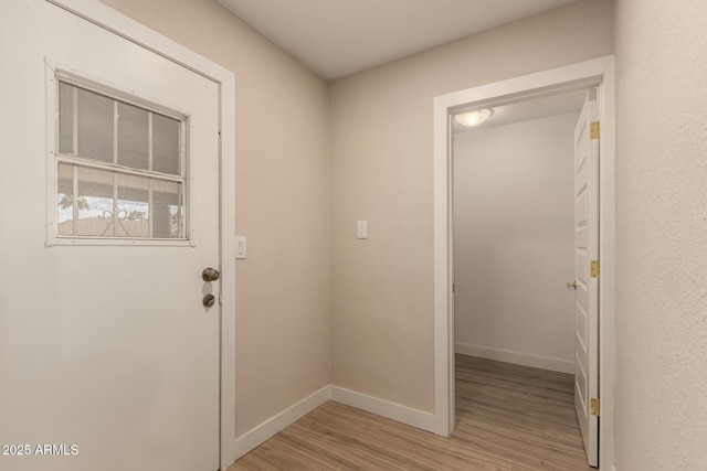 entryway with baseboards and light wood-type flooring