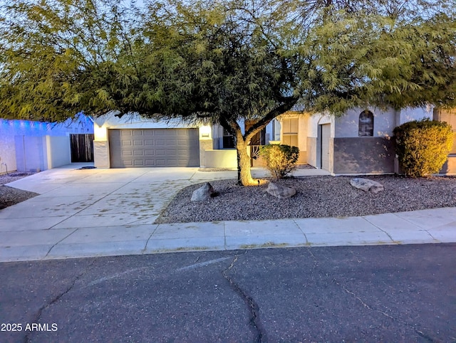 view of property hidden behind natural elements with a garage