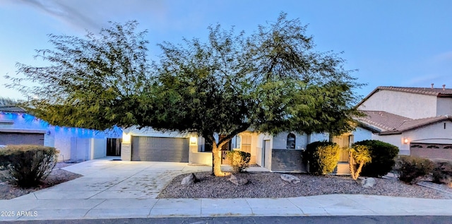 view of property hidden behind natural elements featuring a garage