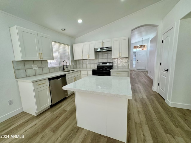 kitchen featuring under cabinet range hood, white cabinetry, stainless steel appliances, and a sink