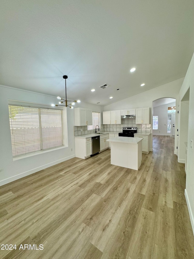 kitchen with appliances with stainless steel finishes, arched walkways, visible vents, and decorative backsplash