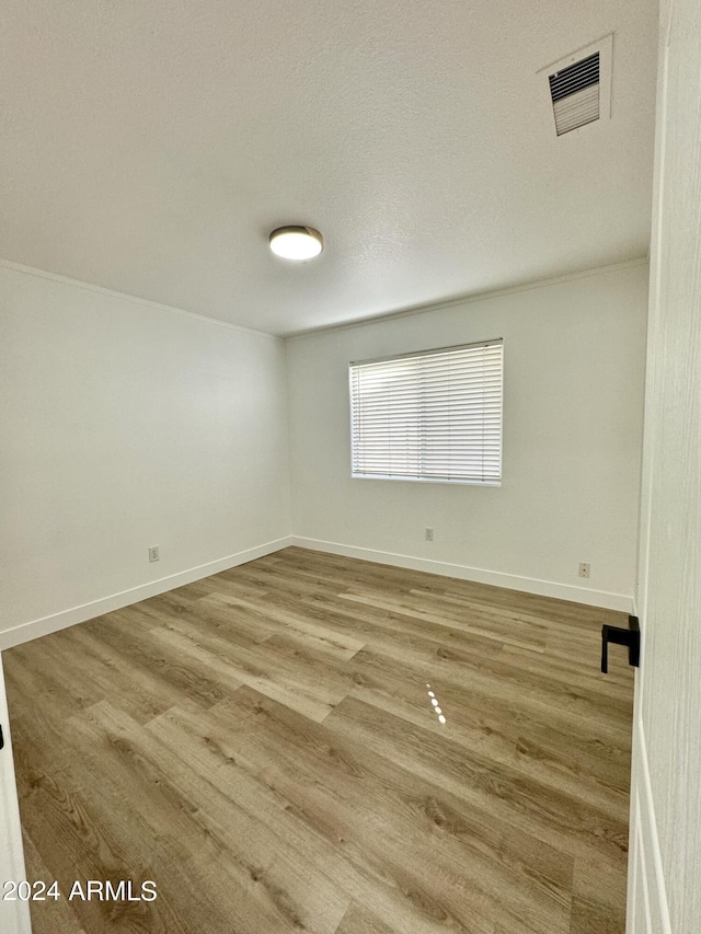 5984 W Geronimo Ct, Chandler, AZ 85226 - spare room featuring baseboards, a textured ceiling, visible vents, and wood finished floors