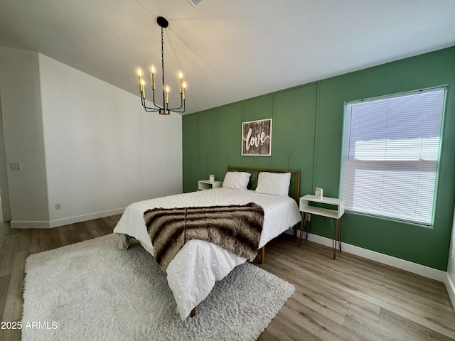 5984 W Geronimo Ct, Chandler, AZ 85226 - bedroom featuring baseboards, wood finished floors, and a chandelier