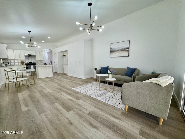 5984 W Geronimo Ct, Chandler, AZ 85226 - living area with baseboards, light wood-style flooring, and a notable chandelier