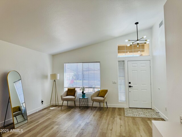 5984 W Geronimo Ct, Chandler, AZ 85226 - foyer with wood finished floors, a notable chandelier, lofted ceiling, and visible vents