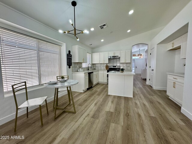 5984 W Geronimo Ct, Chandler, AZ 85226 - kitchen featuring visible vents, decorative backsplash, white cabinetry, and a chandelier