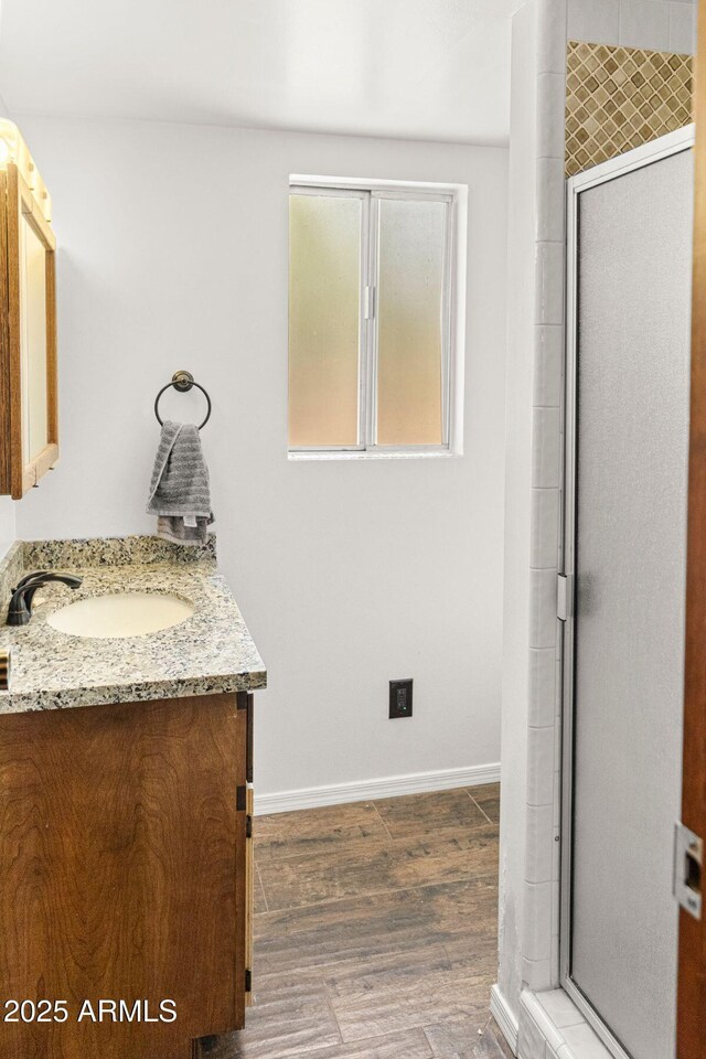 2452 Daisy Trl, Forest Lakes, AZ 85931 - bathroom with vanity, baseboards, a shower with shower door, and wood finished floors