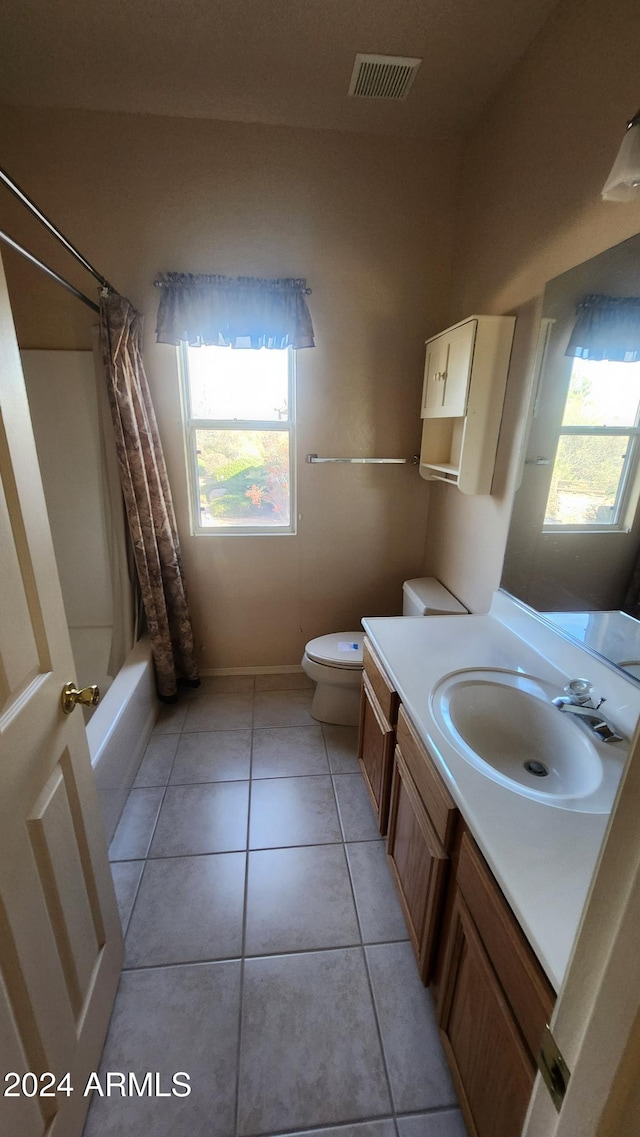 full bathroom with tile patterned flooring, vanity, shower / tub combo, and toilet