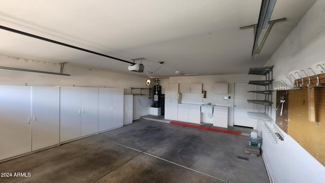 garage featuring sink, a garage door opener, and water heater