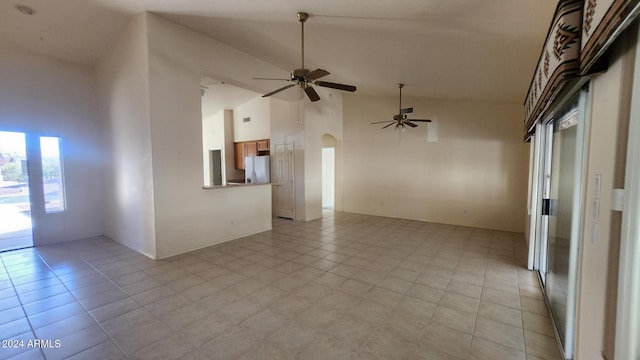 spare room featuring ceiling fan, light tile patterned floors, and high vaulted ceiling