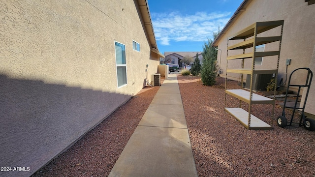 view of side of home featuring central AC