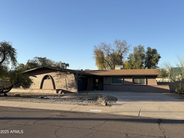 ranch-style house with concrete driveway