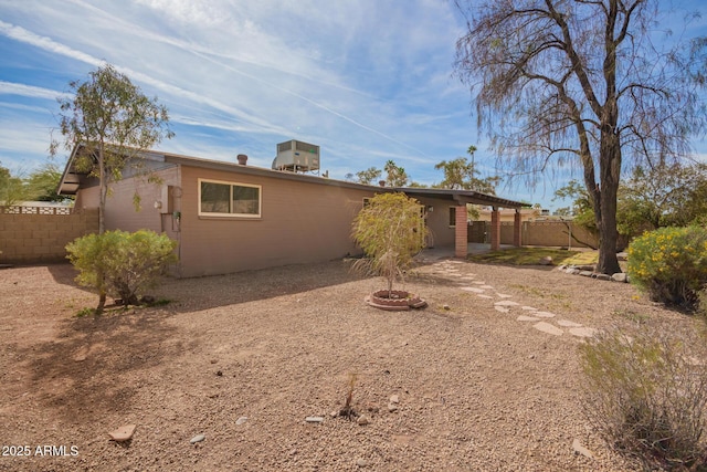 rear view of house with fence