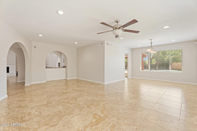 unfurnished room with recessed lighting, arched walkways, ceiling fan, and visible vents