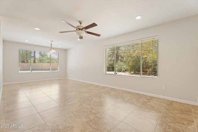 empty room featuring light tile patterned floors, baseboards, ceiling fan with notable chandelier, and recessed lighting
