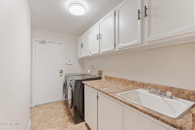 laundry room featuring a sink, cabinet space, and independent washer and dryer
