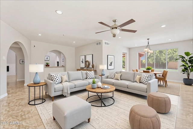 living area with recessed lighting, visible vents, and ceiling fan with notable chandelier