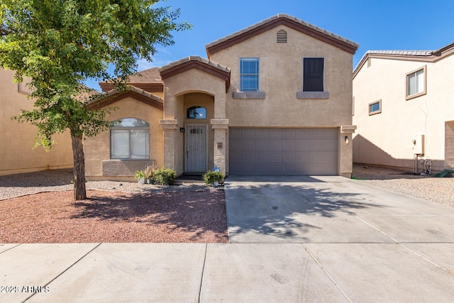 3422 W Sunland Ave, Phoenix, AZ 85041 - mediterranean / spanish house with an attached garage, a tile roof, driveway, and stucco siding