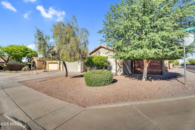 32881 N Hidden Canyon Dr, San Tan Valley, AZ 85144 - obstructed view of property featuring concrete driveway, fence, stucco siding, and a garage