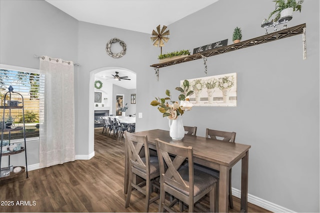 32881 N Hidden Canyon Dr, San Tan Valley, AZ 85144 - dining room with high vaulted ceiling, a ceiling fan, wood finished floors, a fireplace, and baseboards