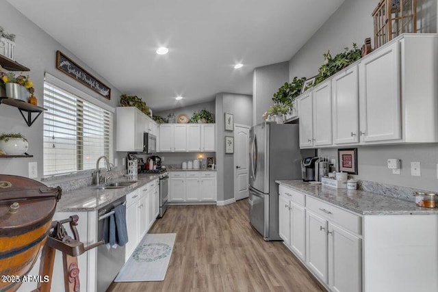 32881 N Hidden Canyon Dr, San Tan Valley, AZ 85144 - kitchen featuring a sink, light wood-type flooring, stainless steel appliances, lofted ceiling, and white cabinetry