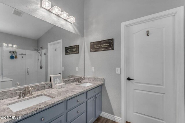 32881 N Hidden Canyon Dr, San Tan Valley, AZ 85144 - bathroom with double vanity, visible vents, a stall shower, and a sink