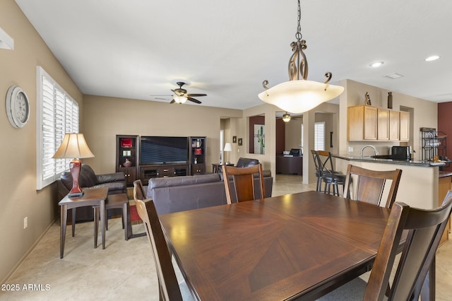 dining space with a healthy amount of sunlight, baseboards, a ceiling fan, and recessed lighting