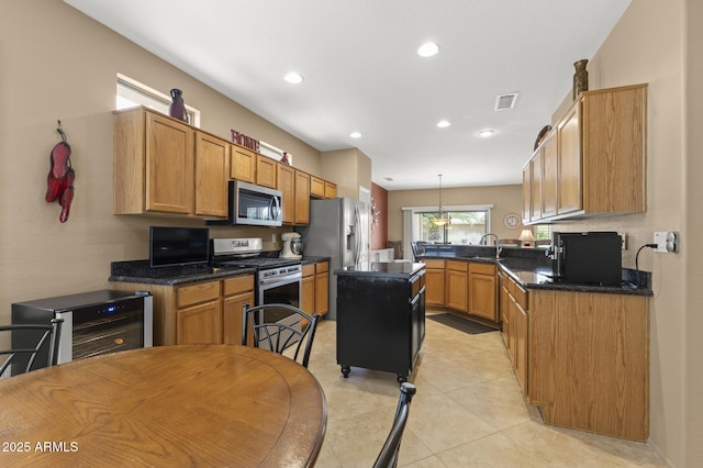 kitchen with stainless steel appliances, dark countertops, visible vents, light tile patterned flooring, and beverage cooler