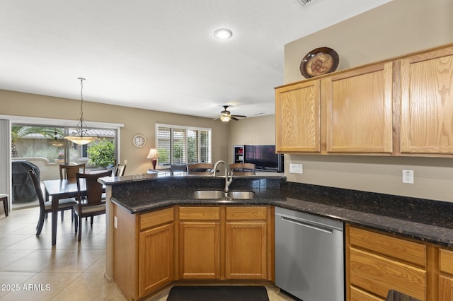 kitchen with light tile patterned floors, hanging light fixtures, stainless steel dishwasher, a sink, and a peninsula