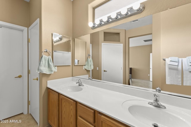 full bathroom featuring double vanity, visible vents, and a sink