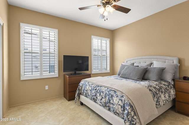 bedroom featuring a ceiling fan, baseboards, and tile patterned floors