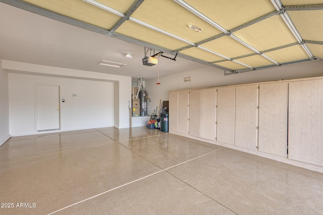 garage featuring gas water heater and a garage door opener