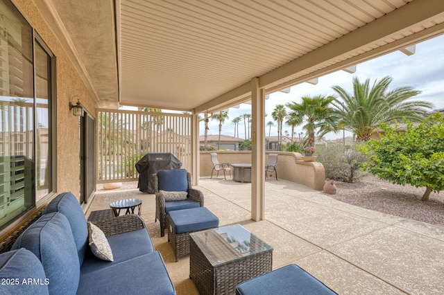 view of patio / terrace featuring a grill, fence, and outdoor lounge area