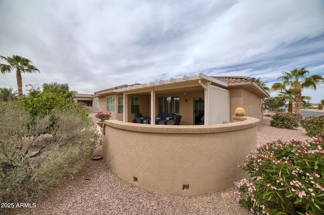 exterior space featuring a tile roof and stucco siding