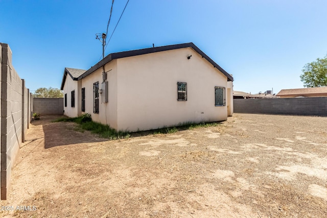 3614 W Granada Rd, Phoenix, AZ 85009 - rear view of property with stucco siding and a fenced backyard