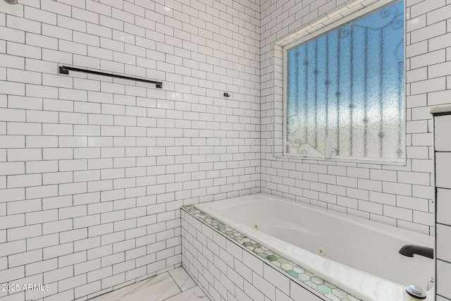 3614 W Granada Rd, Phoenix, AZ 85009 - bathroom featuring a tub with jets, marble look tile flooring, and tile walls