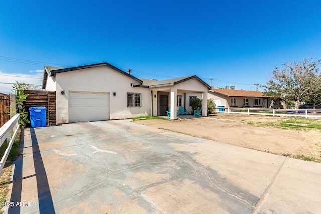 3614 W Granada Rd, Phoenix, AZ 85009 - ranch-style house with a garage, stucco siding, and driveway