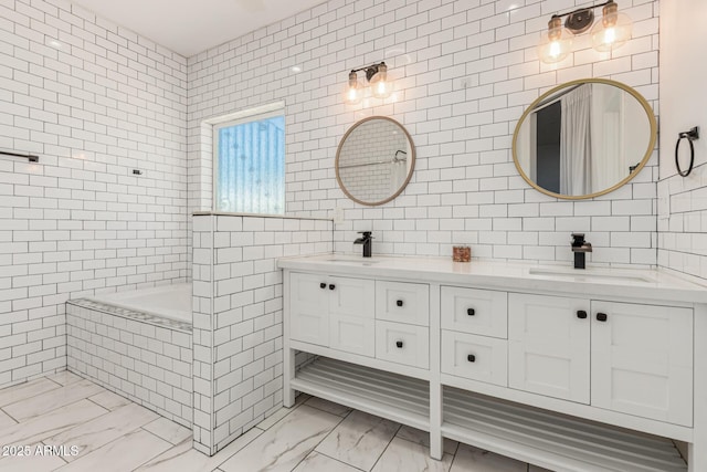3614 W Granada Rd, Phoenix, AZ 85009 - full bath featuring tile walls, double vanity, marble finish floors, and tiled tub