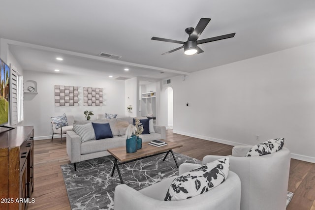 living room featuring hardwood / wood-style floors and ceiling fan