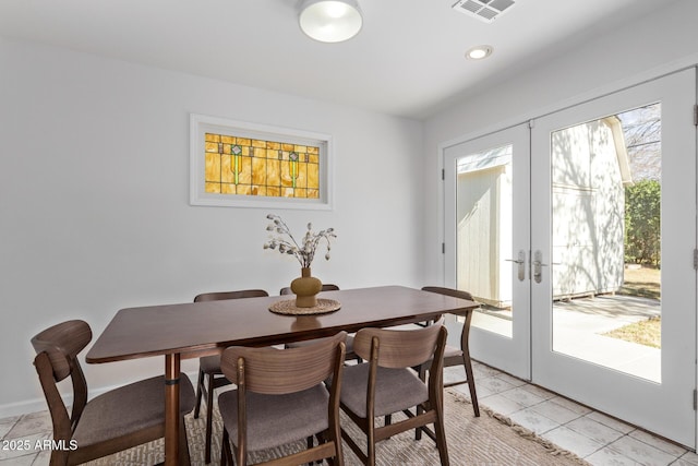 tiled dining room featuring french doors