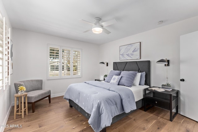 bedroom with wood-type flooring and ceiling fan