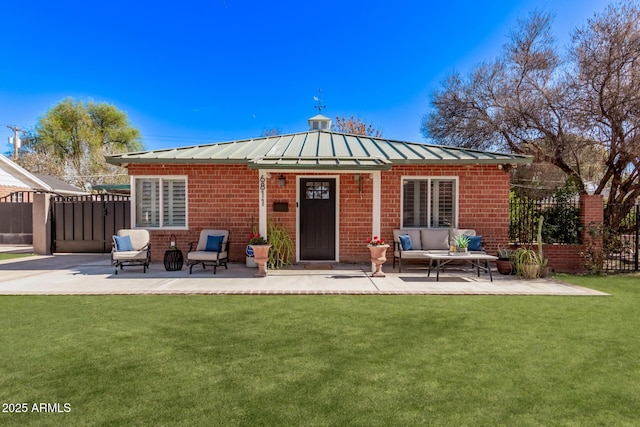 back of house with an outdoor living space, a yard, and a patio