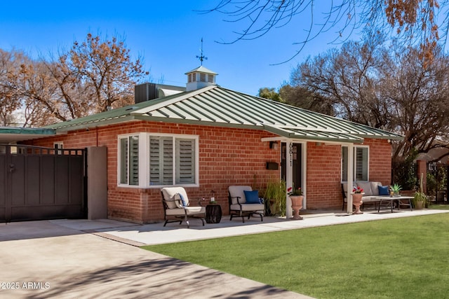 rear view of property with outdoor lounge area, a yard, and a patio area