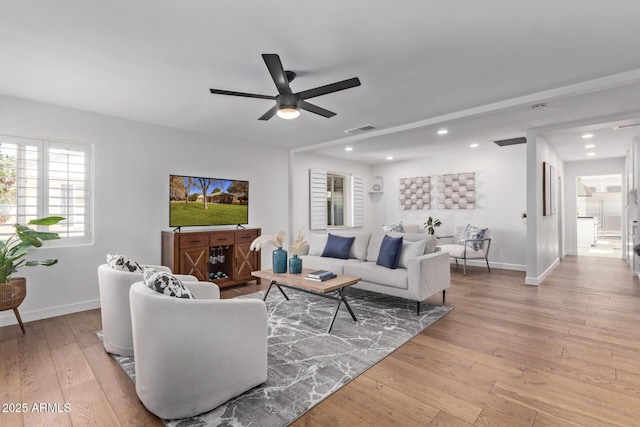 living room featuring ceiling fan and light wood-type flooring