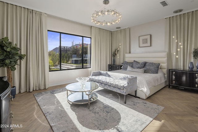 bedroom with parquet floors and an inviting chandelier