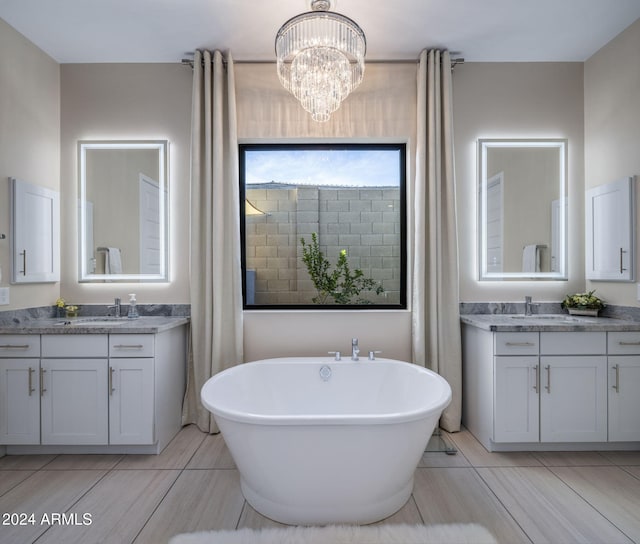 bathroom with vanity and a tub