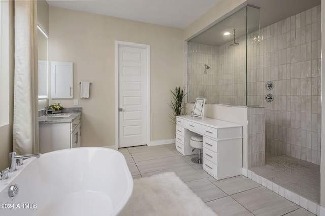 bathroom with vanity, plus walk in shower, and tile patterned flooring