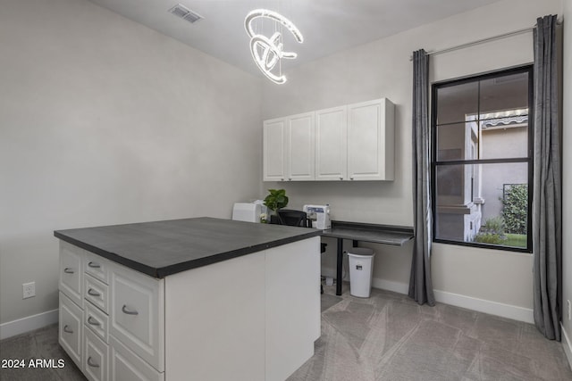 unfurnished office featuring an inviting chandelier and light carpet